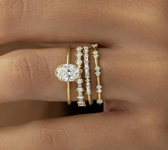 Bridal ring stack with engagement ring and layered wedding bands, anniversary rings